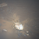 Ingenuity caught a picture of the Perseverance backshell and parachute, which helped the rover land.